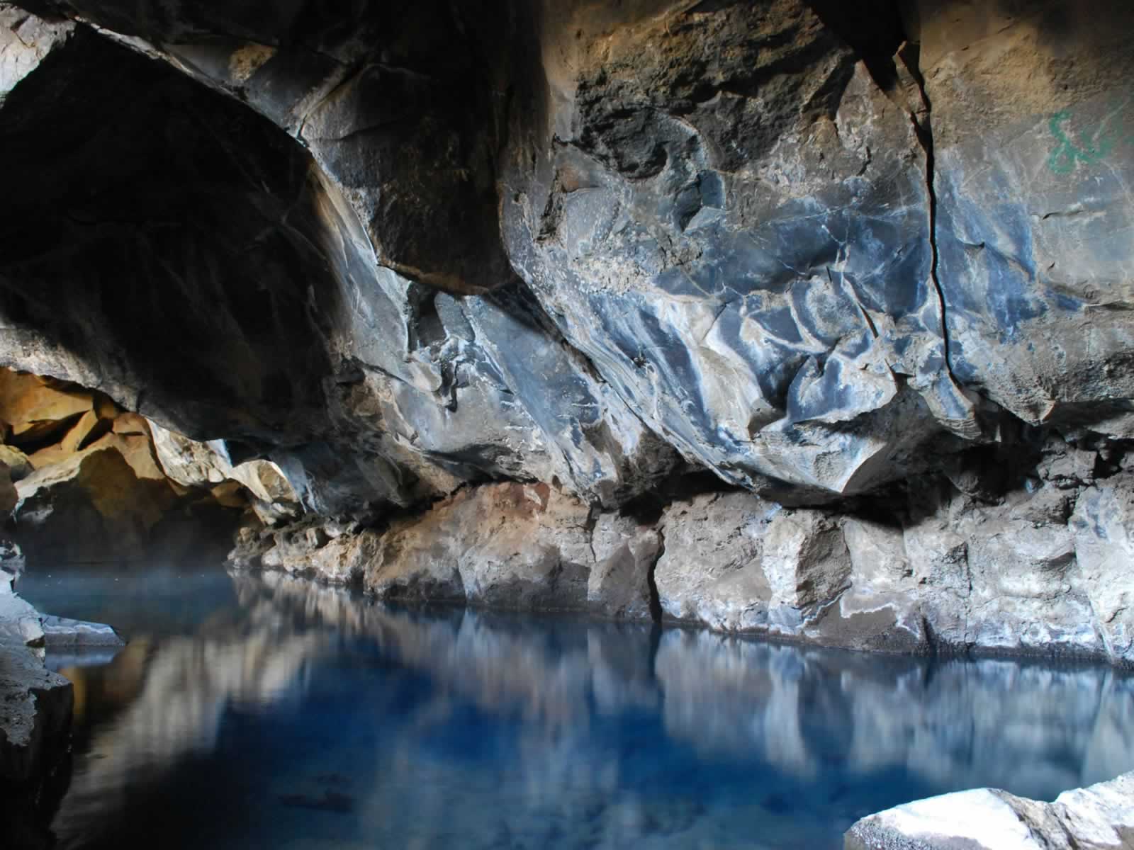 A cave with water and rocks in it